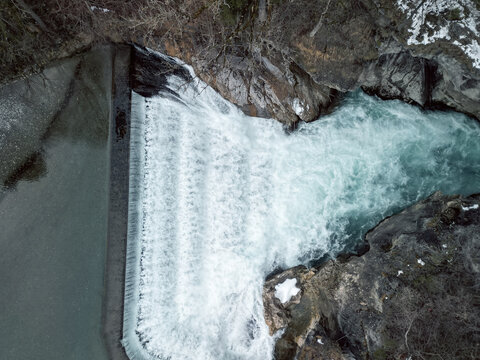 water that flows through the lech fall and is on its way towards the valley. Photographed from a bridge that leads over the Lech. Recorded in winter.