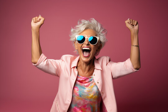 Senior woman looking happy and joyful full of energy. doing rock poses in front of a seamless background. Generative AI