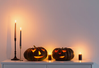 black halloween pumpkin with burning candles in white interior