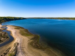 Aerial shot over West Neck Beach on Long Island in the suburb of Lloyd Harbor New York on sunny day