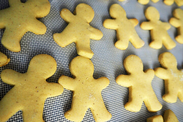 on a silicone mat lies warm, freshly cooked gluten-free gingerbread cookies.  side view