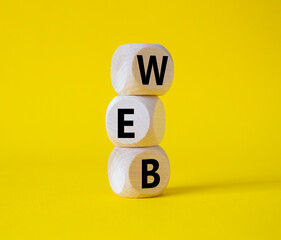 Web symbol. Wooden cubes with word Web. Beautiful yellow background. Business and Web concept. Copy space.