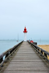 Trouville-sur-Mer lighthouse against a blue sky in France