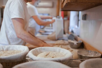Baker working in the kitchen, preparing loaves of bread