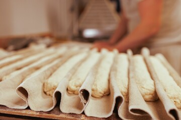 Baker working in the kitchen, preparing loaves of bread