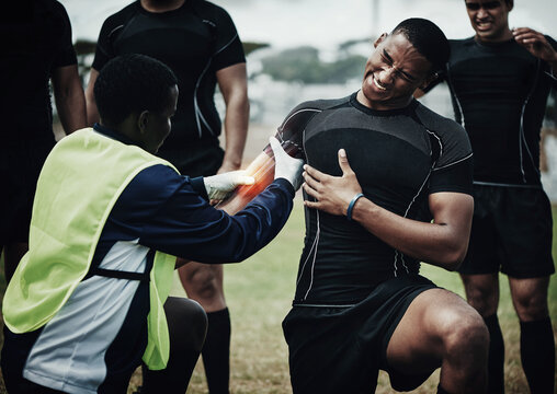 Rugby player, muscle injury and field with pain, team doctor and broken bone in game, overlay and helping hand. Athlete, emergency or accident with sports medic, torn bicep and red glow for fitness