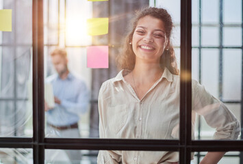 Smiling business woman looking out the window.