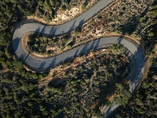 An aerial shot of Old pine canyon road between the green lush trees