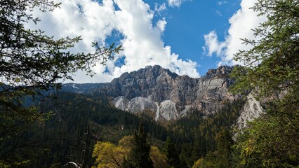Scenic shot of a mountainous landscape with trees in the foreground in Sichuan Province, China
