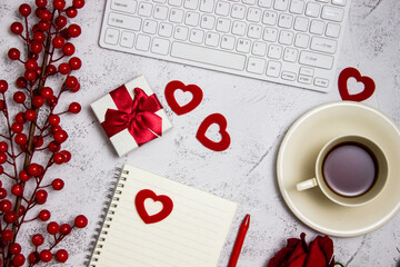 Office work items and red concept with coffee cup, notebook, gift box on a marble background. 