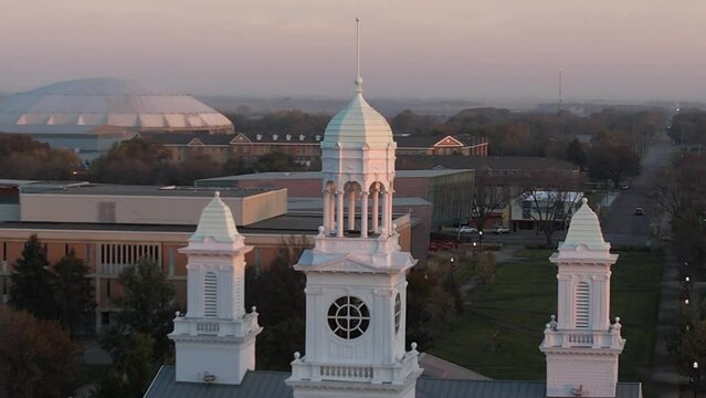 Drone footage showing the Vermillion Campus white tower with lawns at sunset in Minnesota