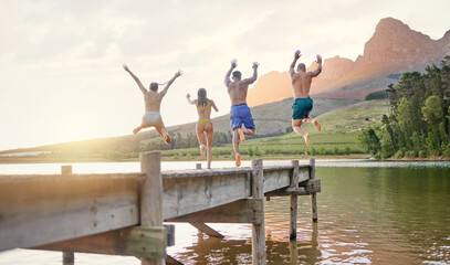 Lake, jump and group of friends for holiday, summer camping and freedom, celebration or success...