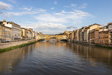 Fototapeta na wymiar The Arno river in Florence Italy with Ponte Vecchio, the historic bridge from a distance.