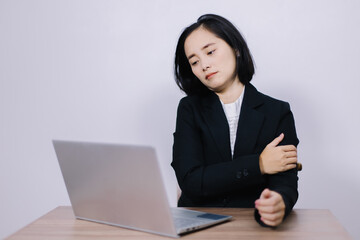 Concept Office Syndrome, Young Asian female office worker is tired from hard work, shoulder pain due to working hours consecutively.