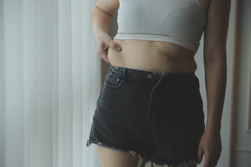fat woman, fat belly, chubby, obese woman hand holding excessive belly fat with measure tape, woman...