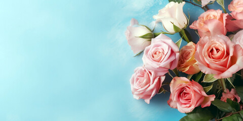 Bouquet of pink and red roses on blue background with copy space