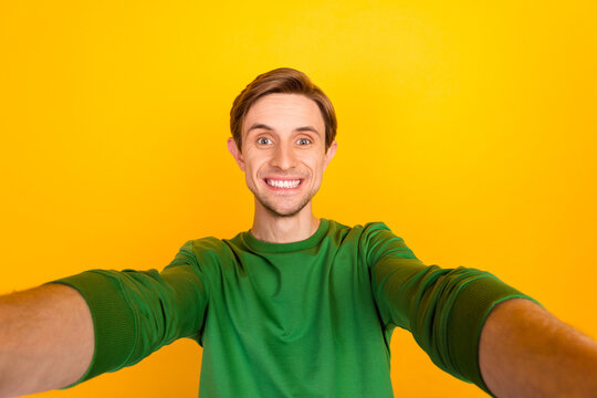 Photo of young guy making selfie portrait speak video call chat friends isolated yellow color background