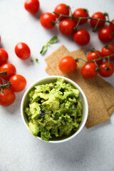 Homemade avocado dip with ripe tomatoes
