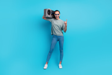 Full body photo of happy cheerful woman boom box music lover show rocker sign isolated on blue color background