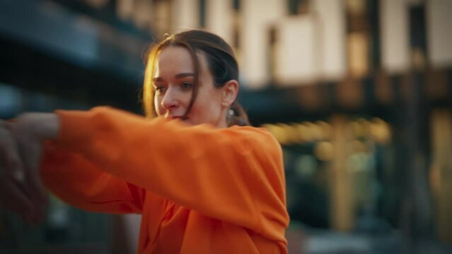 Close-Up Shot of Young Stylish Female Hip Hop Dancer Freestyling On City Street. Professional Newstyle Performer Doing Improvisation In Urban Environment. Caucasian Woman Practicing Choreography.
