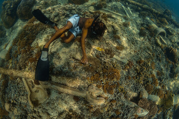 26 March 2019 near island Gilli, Indonesia. Young man exploring coral reef. Underwater sport and...