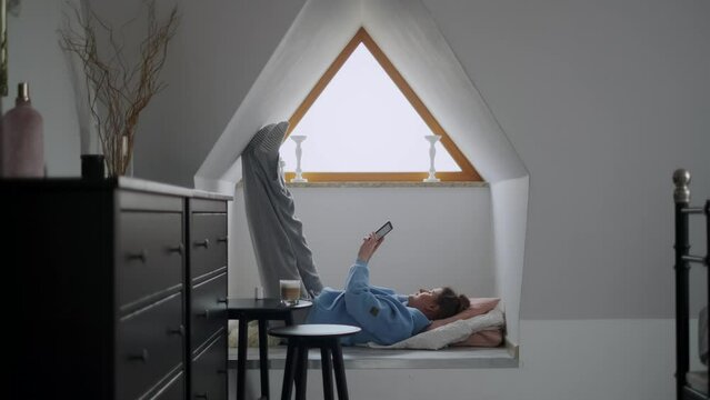 Woman reads e-book in her cozy apartment, 4k