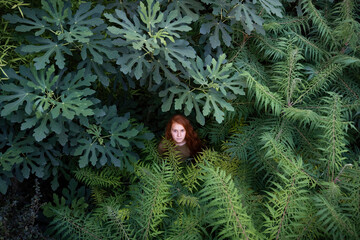Girl standing amidst plants in nature