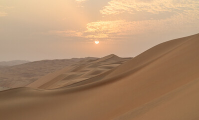 Fototapeta na wymiar Sand Dunes in the Desert outside Abu Dhabi at Sunset- Empty Quarter, United Arab Emirates 