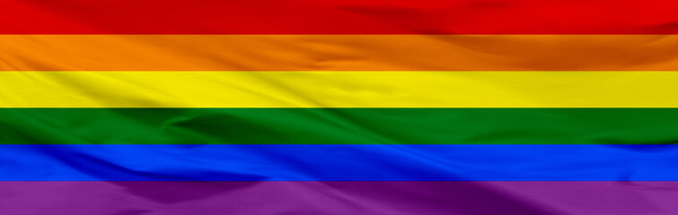 Waving LGBT flag. LGBT flag close-up.. The gay pride rainbow flag. Banner of rainbow flag