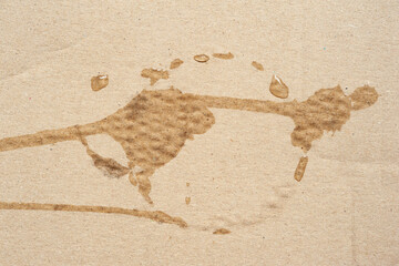 Cardboard texture with wet spots. Brown cardboard with round wet spots of water. Cardboard with surface texture