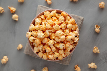 Homemade Cheese Popcorn in a Bowl on a gray background, top view.