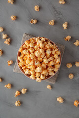 Obraz na płótnie Canvas Homemade Cheese Popcorn in a Bowl on a gray background, top view.