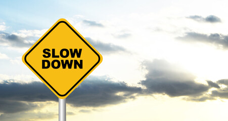 slow down sign on sky background