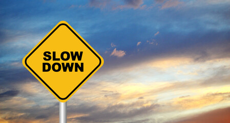 slow down sign on sky background