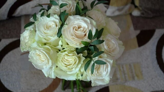 Beautiful wedding bouquet for bride. Arrangement of fresh white roses with green eucalyptus.