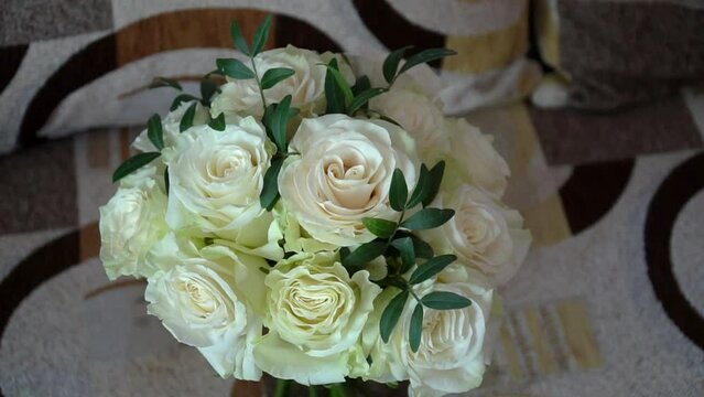 Top view close up of modern bridal bouquet of fresh white roses for wedding celebration.
