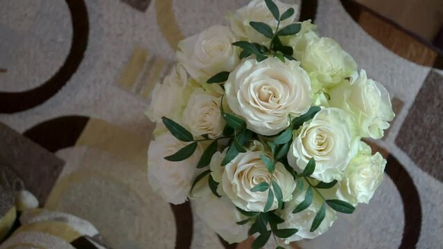 Top view close up of beautiful modern wedding bouquet for bride. Bouquet of fresh white roses.