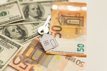 keys and stack of dollars isolated on a white background
