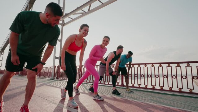 Group of athletes stands at start preparing for race
