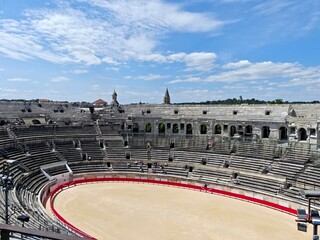 Naklejka premium Nîmes, May 2023 : Visit the beautiful city of Nîmes en Provence - Historical city with its arena and ancient theater - View on the arena 