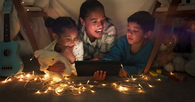 Comedy, tablet and mother streaming children in a tent house laughing at internet video, show or movie online at night. Dark, digital and parent relax with kids watching funny app in the evening