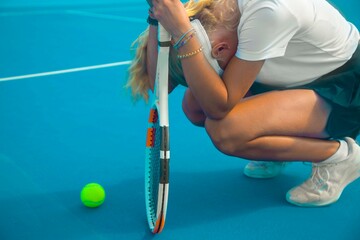 girl tennis player is very worried after losing a tennis match