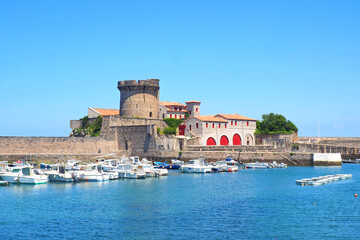 Located in the hollow of the bay of Ciboure and Saint-Jean-de-Luz, Socoa, a small fishing port from where the whalers left in the Middle Ages, is characterized by the crenellated tower of its fort - obrazy, fototapety, plakaty