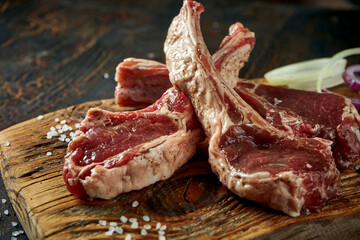 Marinated fresh pork on the bone with spices on a wooden board