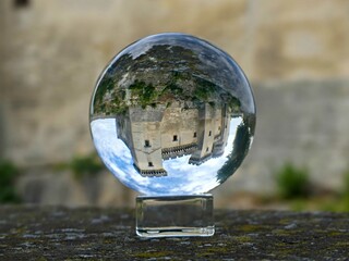 Tarascon, May 2023 : Visit the beautiful city of Tarascon in Provence - View on the castle Through a lens ball - obrazy, fototapety, plakaty