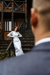 bride on a wooden staircase. wedding day in autumn.