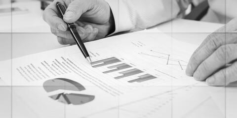 Businessman checking financial graphs, geometric pattern