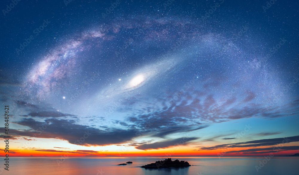 Poster milky way and andromeda galaxy over the sea with sunset reflection on the sea 