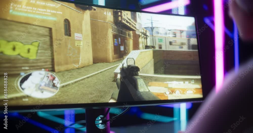 Poster close up of a female gamer girl playing first-person shooter online video game on a computer. focus 