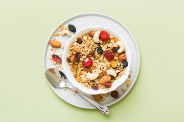 Cooking a wholesome breakfast. Granola with Various dried fruits and nuts in a bowl. The concept of a healthy dessert. Flat lay, top view with copy space